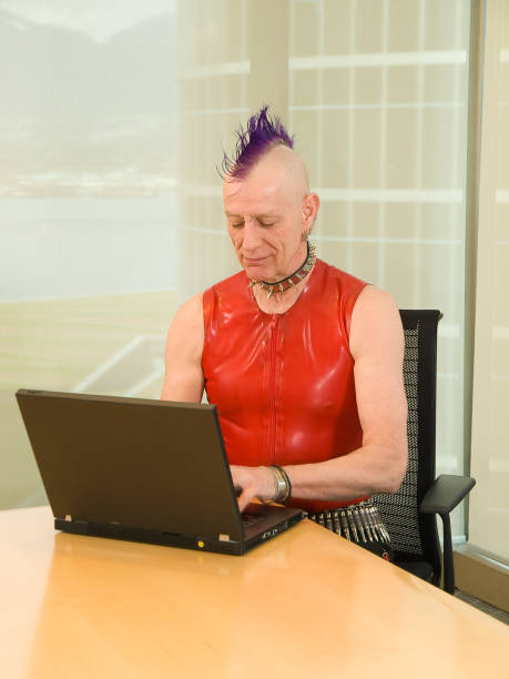 Old Punk Rocker Using Laptop stock photo