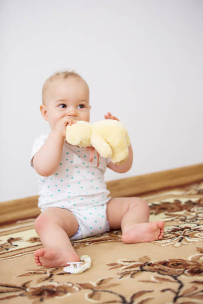 istock Happy baby boy lying with plush toy indoor 922032052