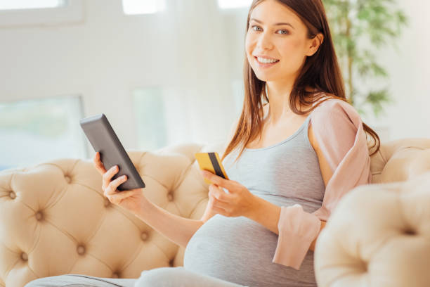 istock Satisfied cute woman looking straight and working with the tablet 922032308