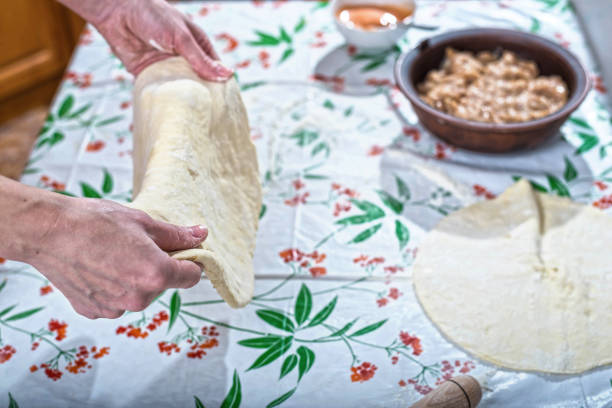 istock Female hands rolling out dough for homemade baking. 922033630