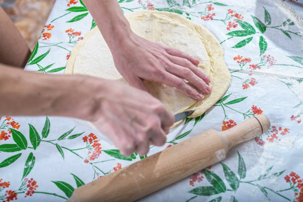 istock Female hands rolling out dough for homemade baking. 922033638