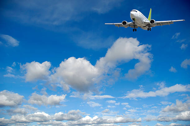istock Air travel - Plane flying in blue sky with clouds 92203527