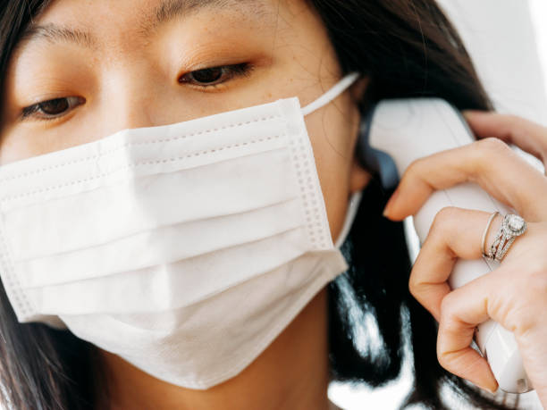 istock A Japanese woman checking the body temperature 922036074