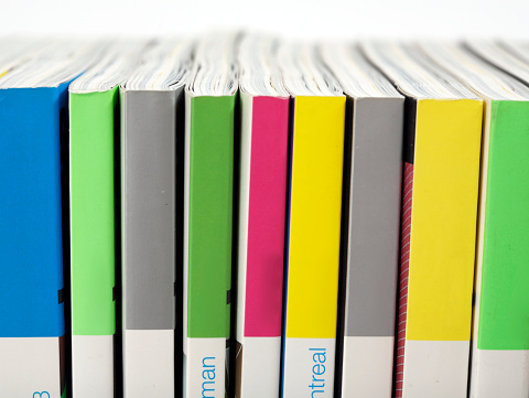 Stack of magazines on white background