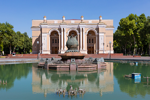 Tashkent, Uzbekistan - May 14, 2017: Reflection of the building of Navoi theatre in the water of the fountain, Tashkent, Uzbekistan.