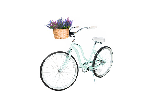 close up view of retro bicycle with basket full of lavender flowers isolated on white