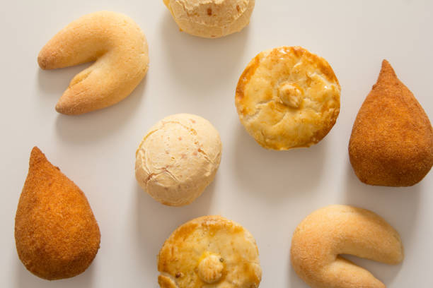 assortiment de collations : pao de queijo, chipa, coxinha et empada. parmi les plats typiques du brésil. top view, design plat laïc sur fond blanc. - empada photos et images de collection