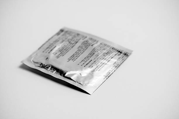 istock Black and white image of condom in silver wrapping 92204717
