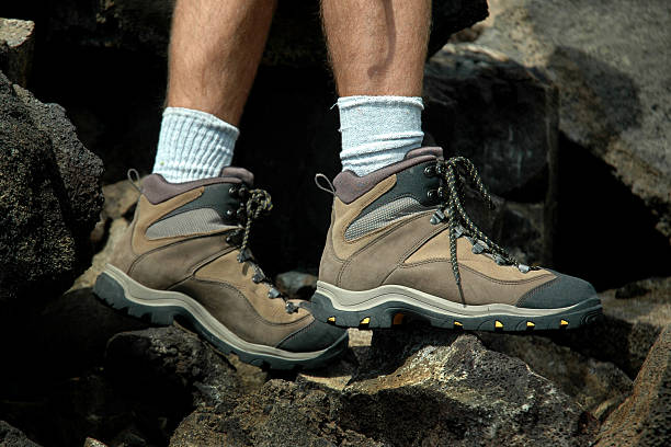 istock Close-up of hiker's boots stepping on rough rocks 92204948