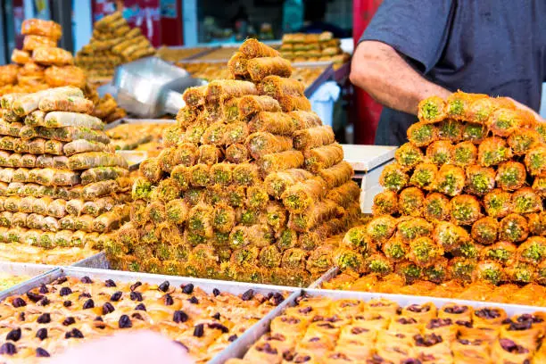 Variety of sweets on the arab street market stall. Eastern sweets in a wide range, baklava, Turkish delight with almond, cashew and pistachio nuts
