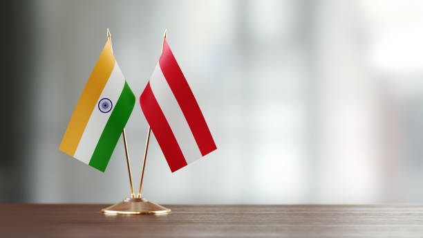 istock Indian And Austrian Flag Pair On A Desk Over Defocused Background 922056556