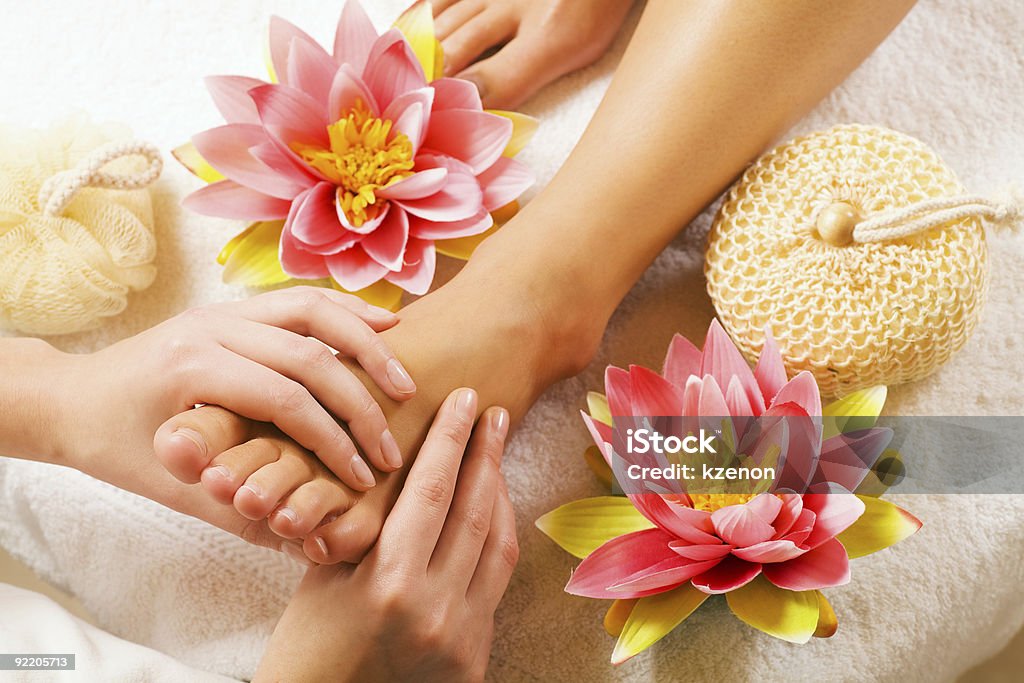 Feet massage Woman enjoying a feet massage in a spa setting (close up on feet) Reflexology Stock Photo