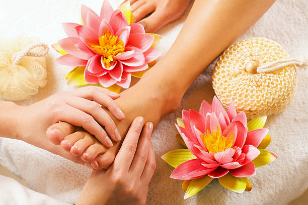 Feet massage Woman enjoying a feet massage in a spa setting (close up on feet) reflexology photos stock pictures, royalty-free photos & images