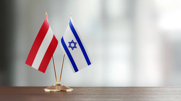 istock Austrian And Israeli Flag Pair On A Desk Over Defocused Background 922058810