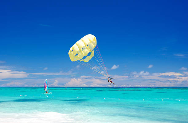 istock Parasailing and wind surfing off of Caribbean beach 92206135