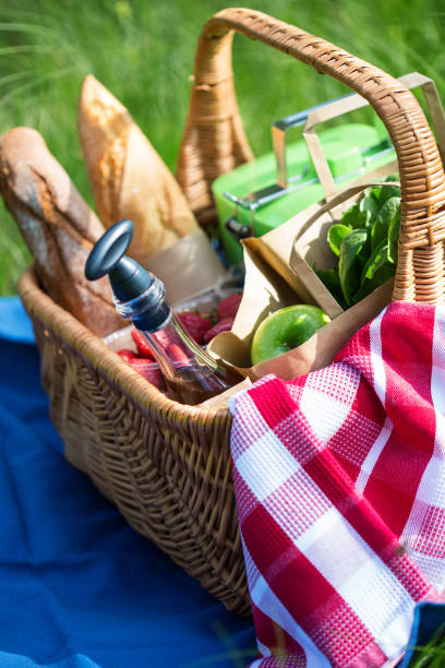 istock Summer picnic basket with snacks on green grass 922063074