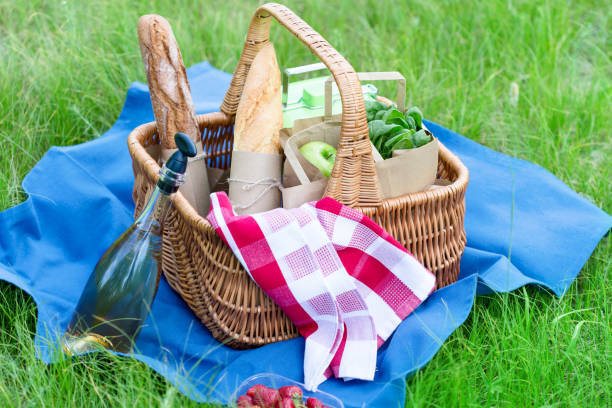 istock Summer picnic basket with snacks on green grass 922063132