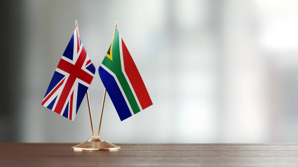 istock British And South African Flag Pair On A Desk Over Defocused Background 922063182