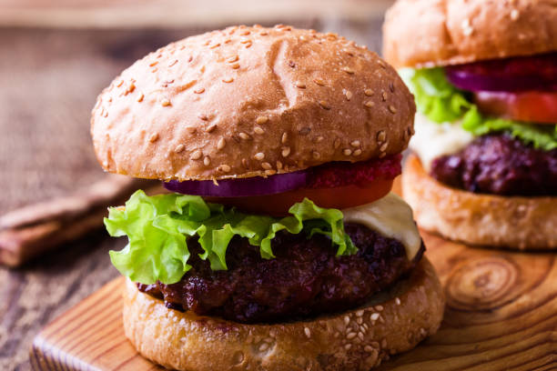 istock Delicious hamburger with lettuce, cheese, tomato, red onion 922063452