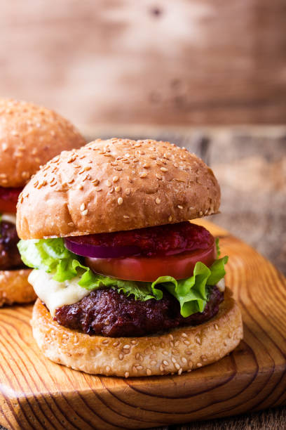 istock Delicious hamburger with lettuce, cheese, tomato, red onion 922063482