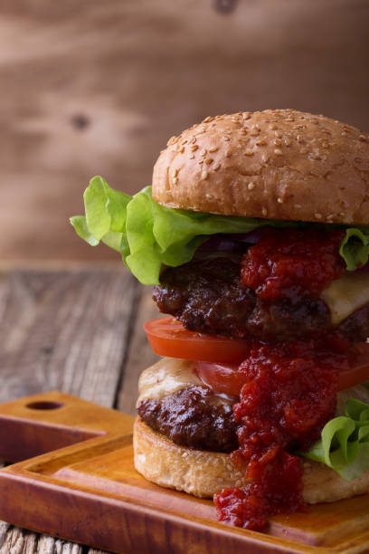 istock Homemade two patty burger with lettuce, cheese, tomato, red onion 922063526