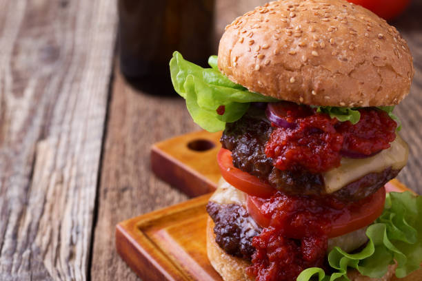 istock Homemade two patty burger with lettuce, cheese, tomato, red onion 922063530