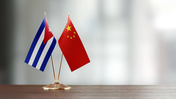 istock Cuban And Chinese Flag Pair On A Desk Over Defocused Background 922063744
