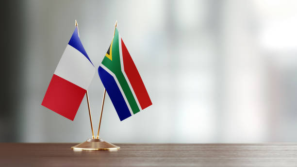 istock French And South African Flag Pair On A Desk Over Defocused Background 922063930
