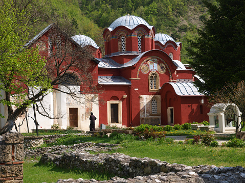 Targu Carbunesti, Romania - July 16 2022: Worshipers at Targu Carbunesti monastery. This is an historic monument monastery in Gorj county, Romania. It dates from 1780.