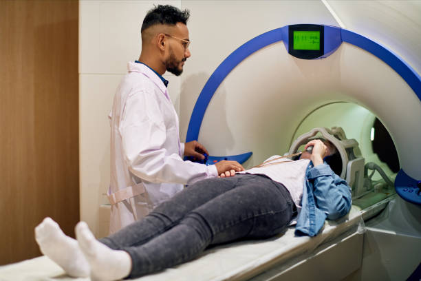 istock Careful young doctor supporting patient before MRI procedure 922071760