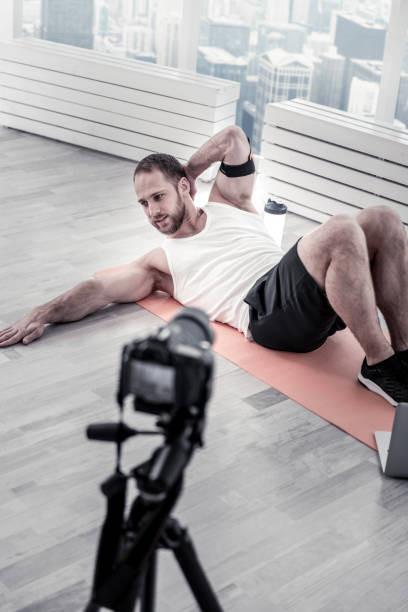 istock Attractive male blogger performing crunching 922071992