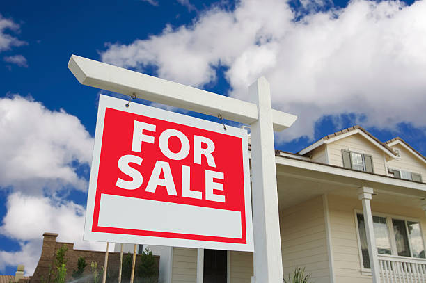 istock Home For Sale Sign and House 92207554