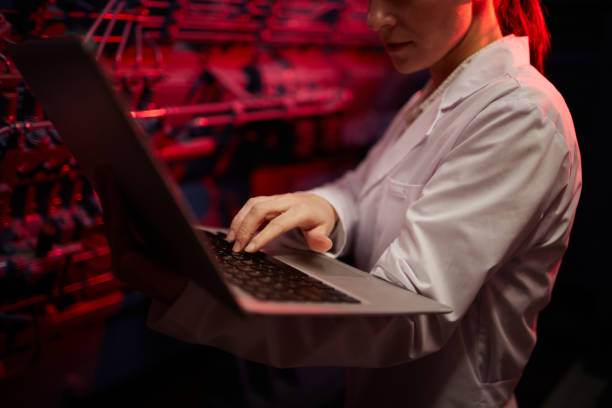 istock Mining farm operator examining equipment with laptop 922077168