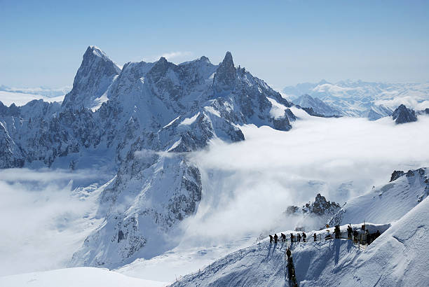 istock Mountain range between white clouds and skiers, the Alps 92207719