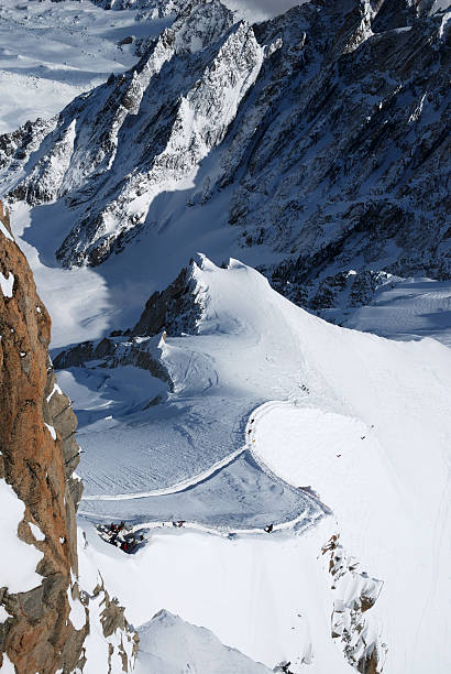 istock Snow slope with skiers between mountain ranges 92207730
