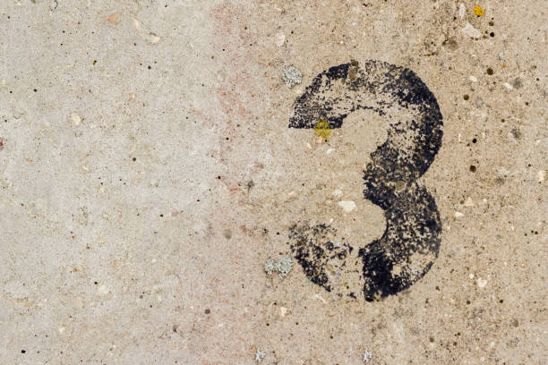 istock Black number three 3 painted on old rugged light grey concrete wall background with copy space 922077422
