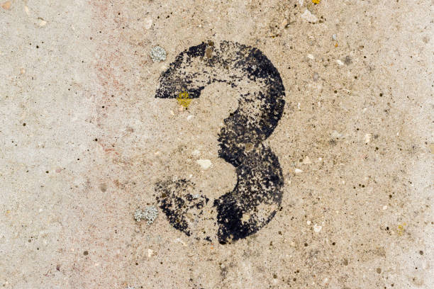 istock Black number three 3 painted on old rugged light grey concrete wall background 922077446