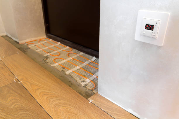 istock Installation of heating elements in warm tile floor and control panel on the wall. Renovation and improvement concept. 922081752