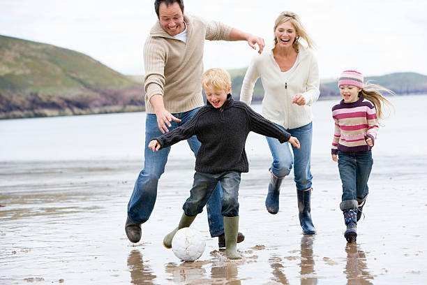 istock Family playing football on beach 92208511