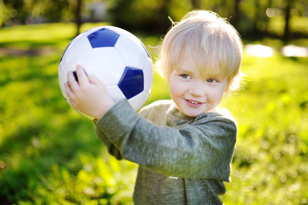 istock Little boy having fun playing a soccer game on sunny summer day 922088732