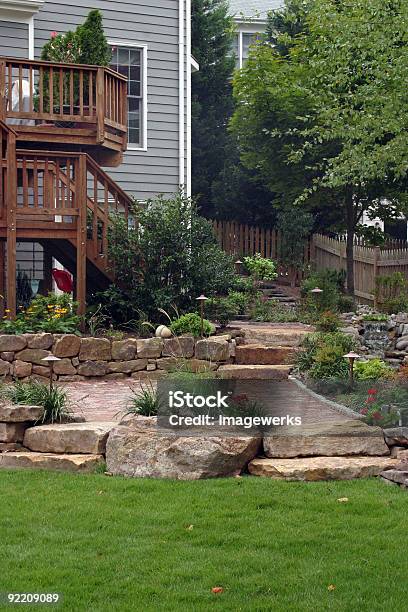 Wooden Deck Leading To Stone Garden Patio Stock Photo - Download Image Now - Yard - Grounds, Stone Wall, Landscaped