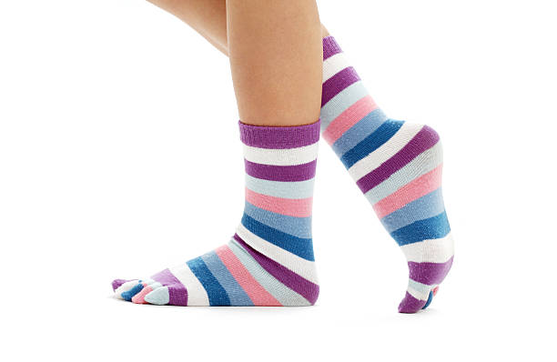 istock female legs in funny striped socks over white 92210085
