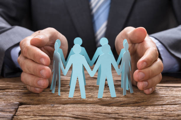 istock Businessman Covering Paper Team With Hands 922102252