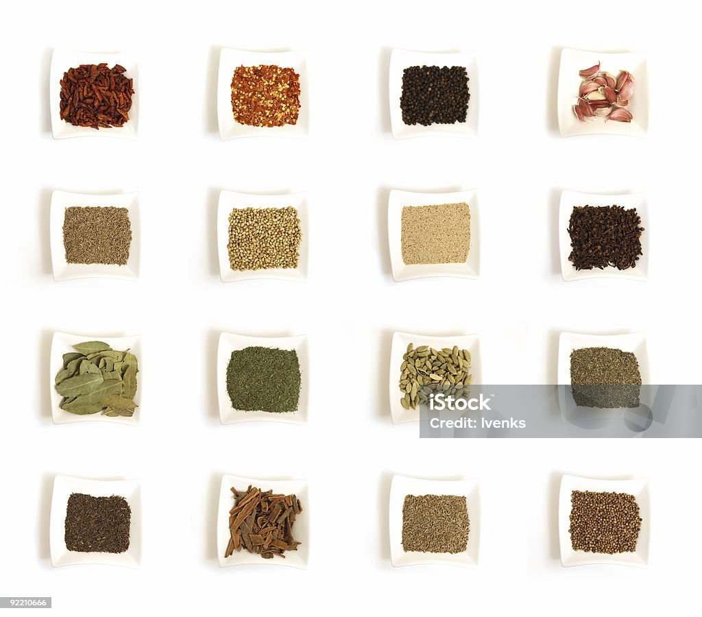 Various kinds of spices in sixteen white square bowls  Backgrounds Stock Photo