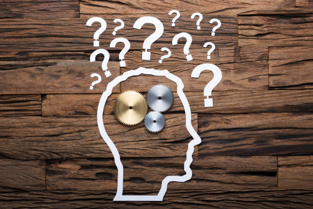 istock Paper Businessman's Head With Gears And Question Marks On Table 922106710