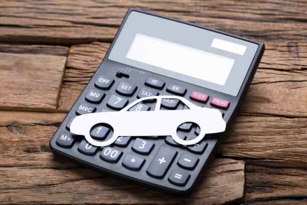 istock Paper Car On Calculator At Wooden Table 922106842