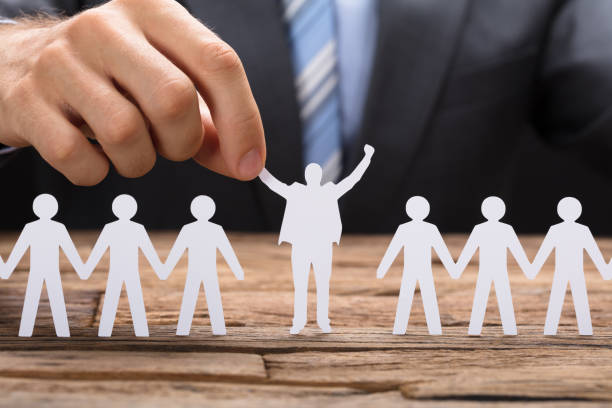 istock Businessman Holding Successful Paper Executive Amidst Teamchain 922106940
