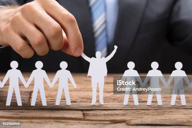 Businessman Holding Successful Paper Executive Amidst Teamchain Stock Photo - Download Image Now