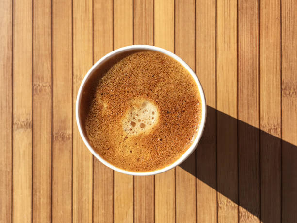 Coffee on Wood Table Coffee on Wood Table black coffee from above stock pictures, royalty-free photos & images