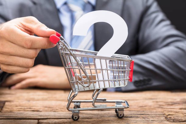 Businessman Pushing Question Mark In Shopping Cart